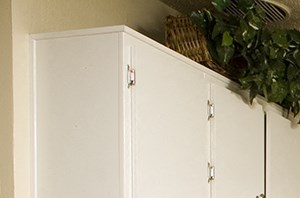 a kitchen with white cabinets and a table